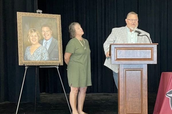 Man and woman at podium