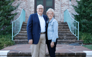 Ward and Joetta Koeser standing in front of the home of the late H.V. Foster's Ranch.